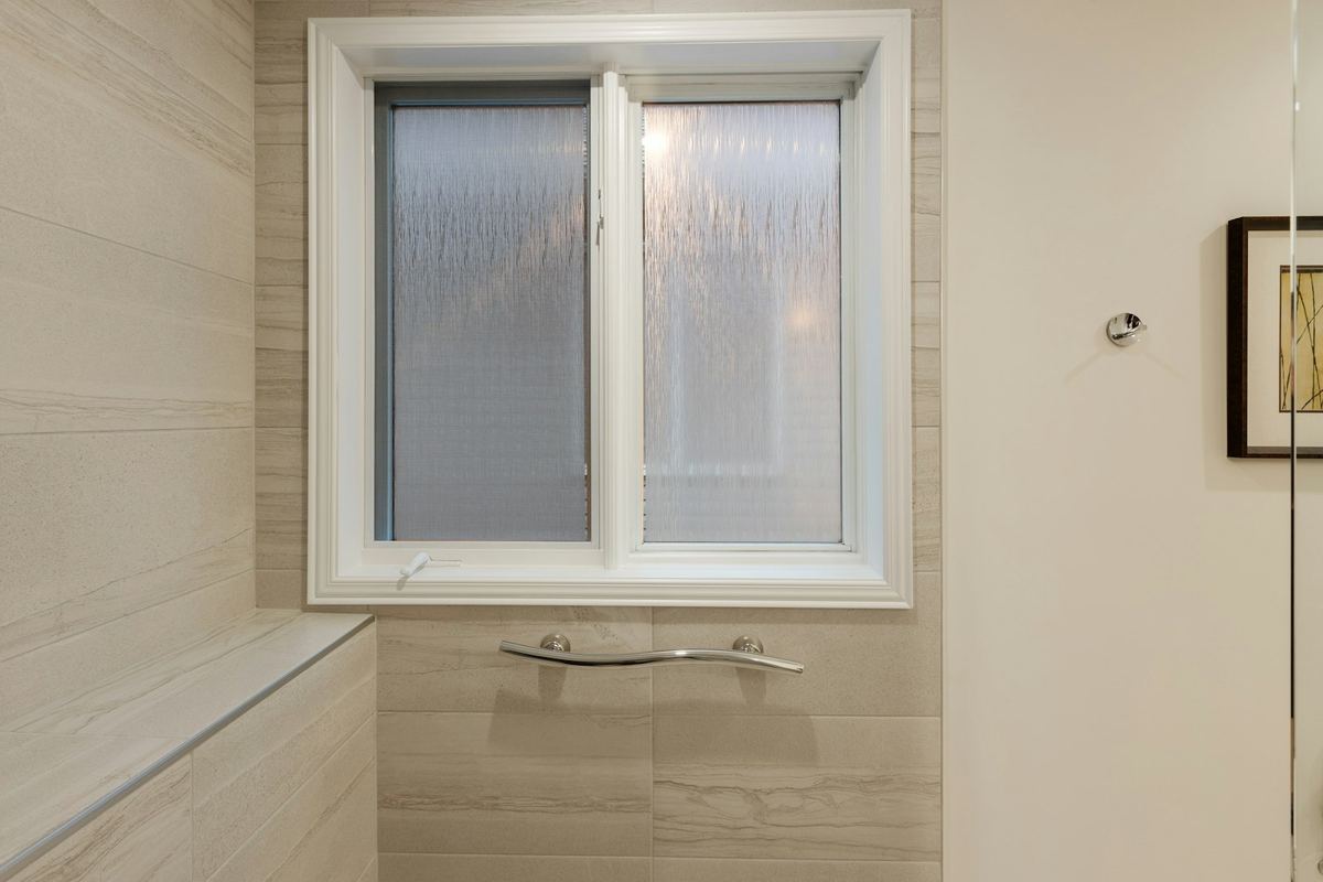 Frosted bathroom window over a tub