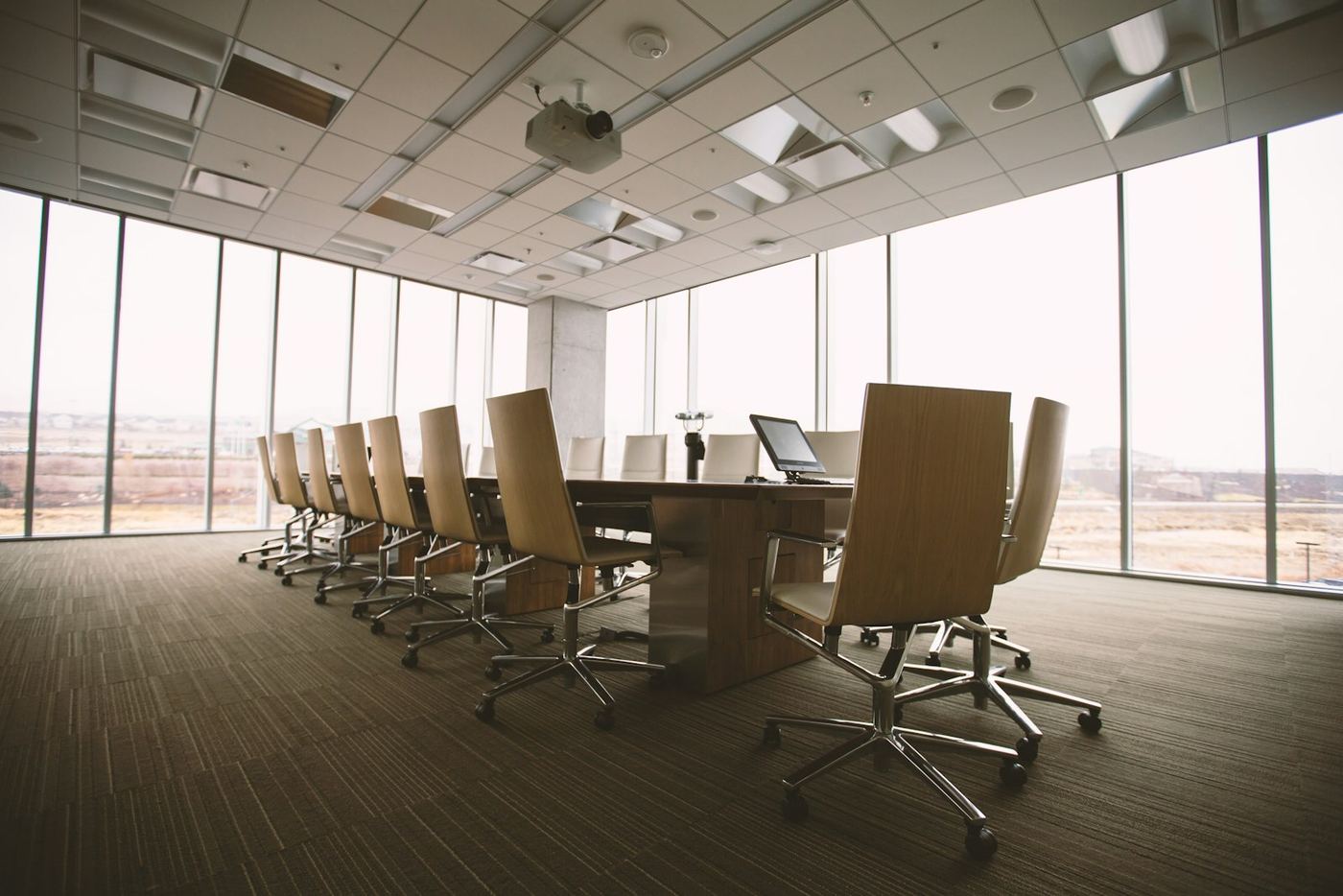 Conference room with a wall of windows and hard afternoon glare