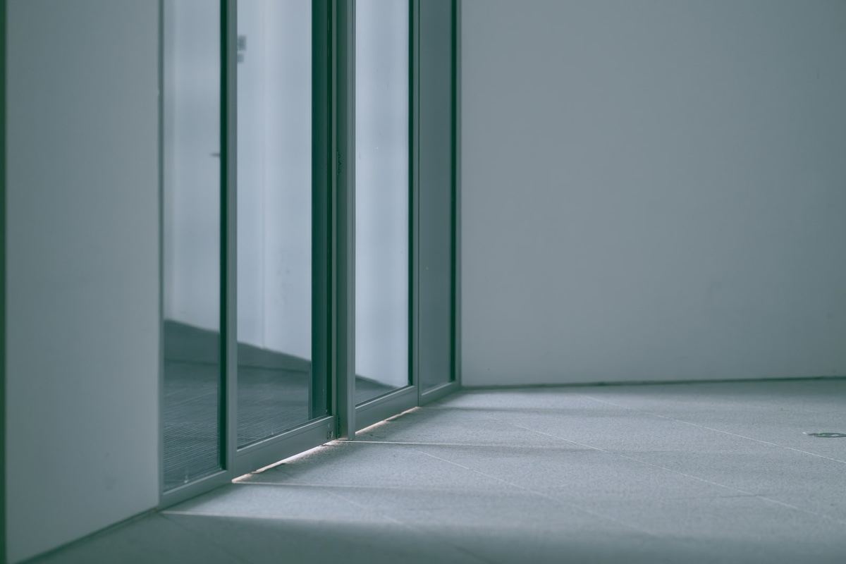 Sliding glass door in an empty, sunlit room