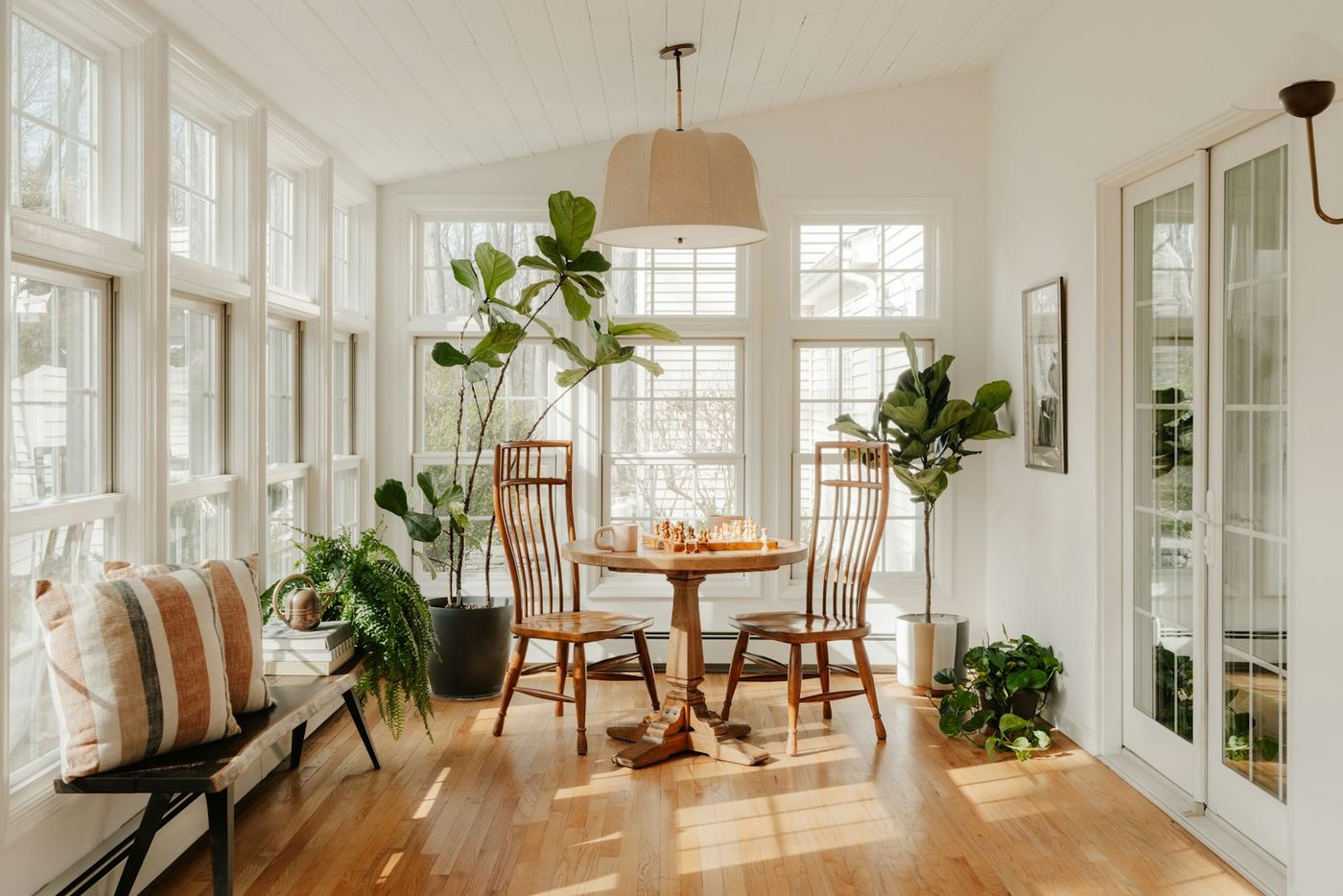 Sunroom with a full wall of windows and a dining table