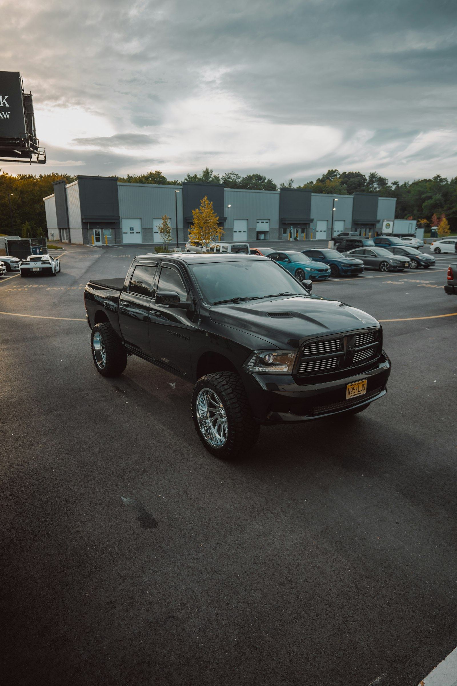 Black pickup with dark tinted windows in a parking lot